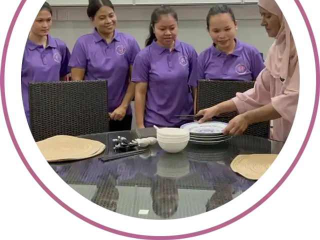 Femme5 helpers learning to set a dining table