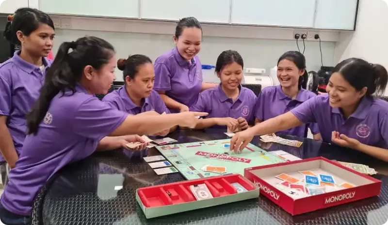 Helpers bonding over a board game at Femme5